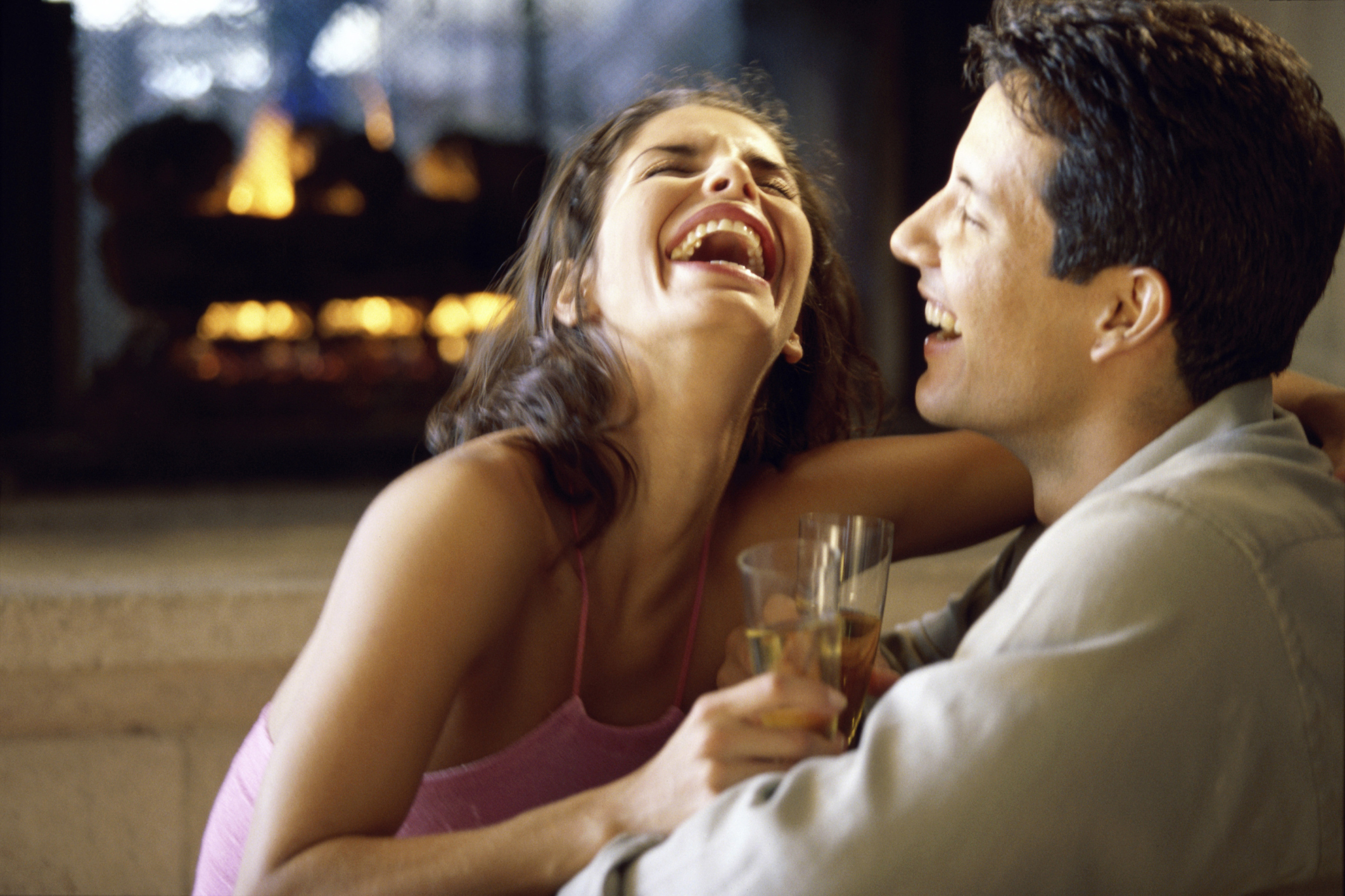 Side profile of a young couple laughing